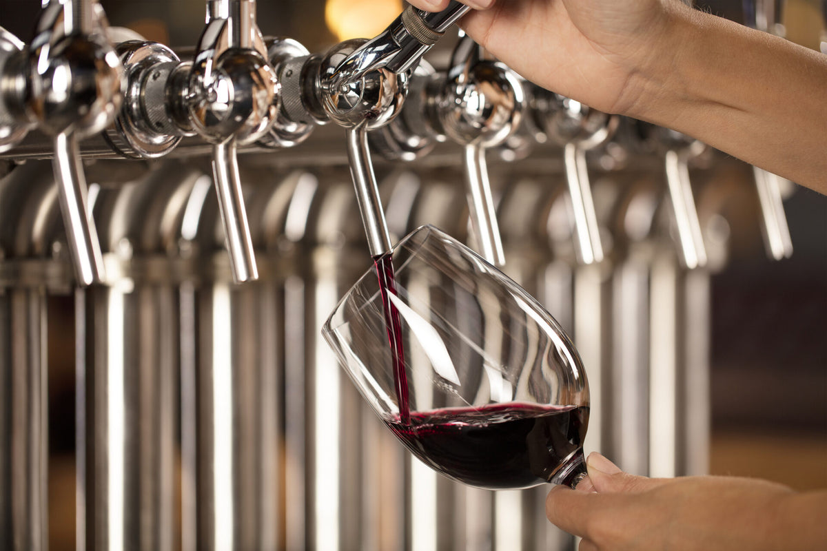 Wine on draft tap system dispensing wine into a glass